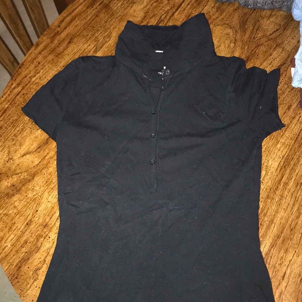 Tight fitted black t shirt with five buttons.